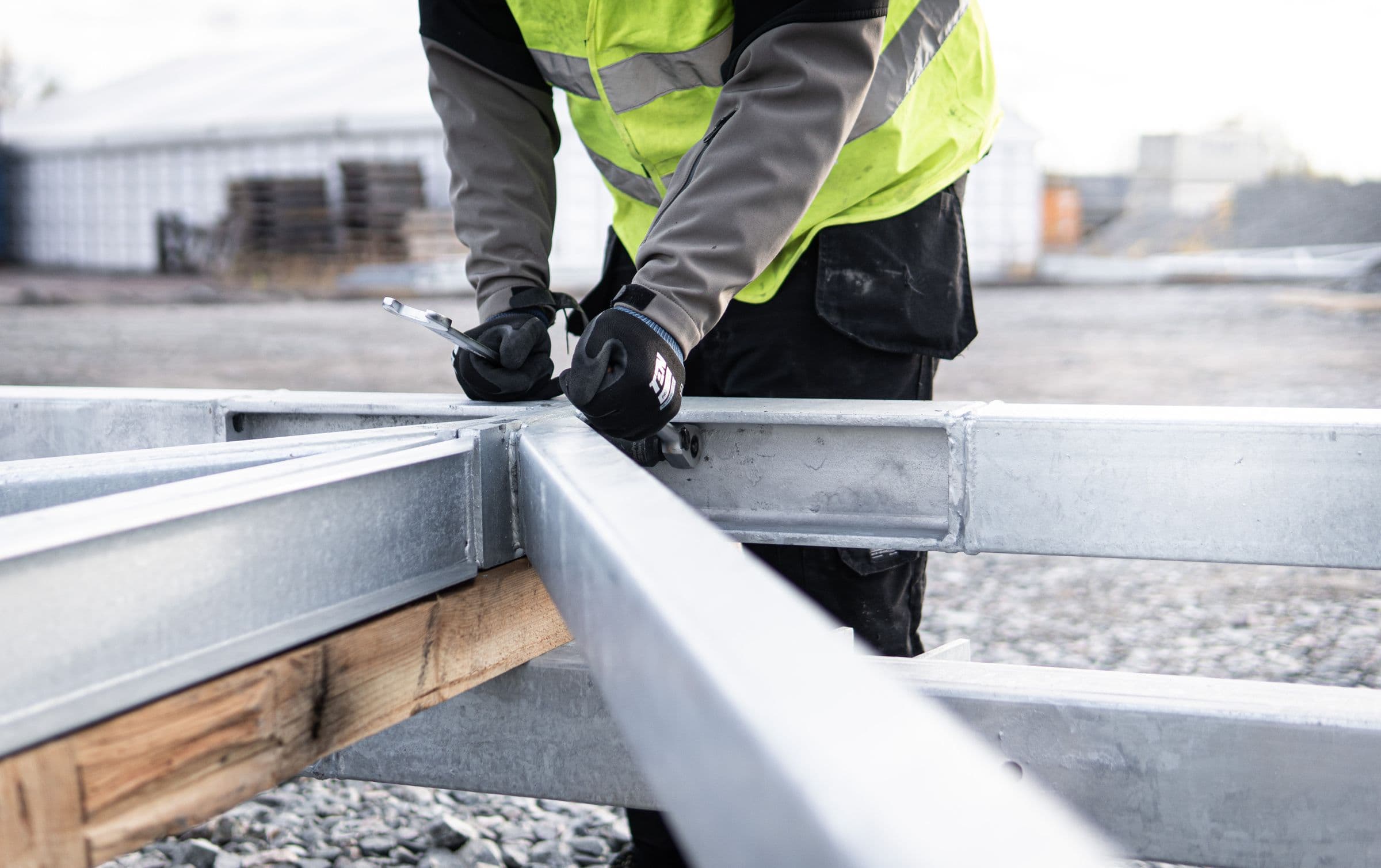 Worker checking a galvanized structural steel connection